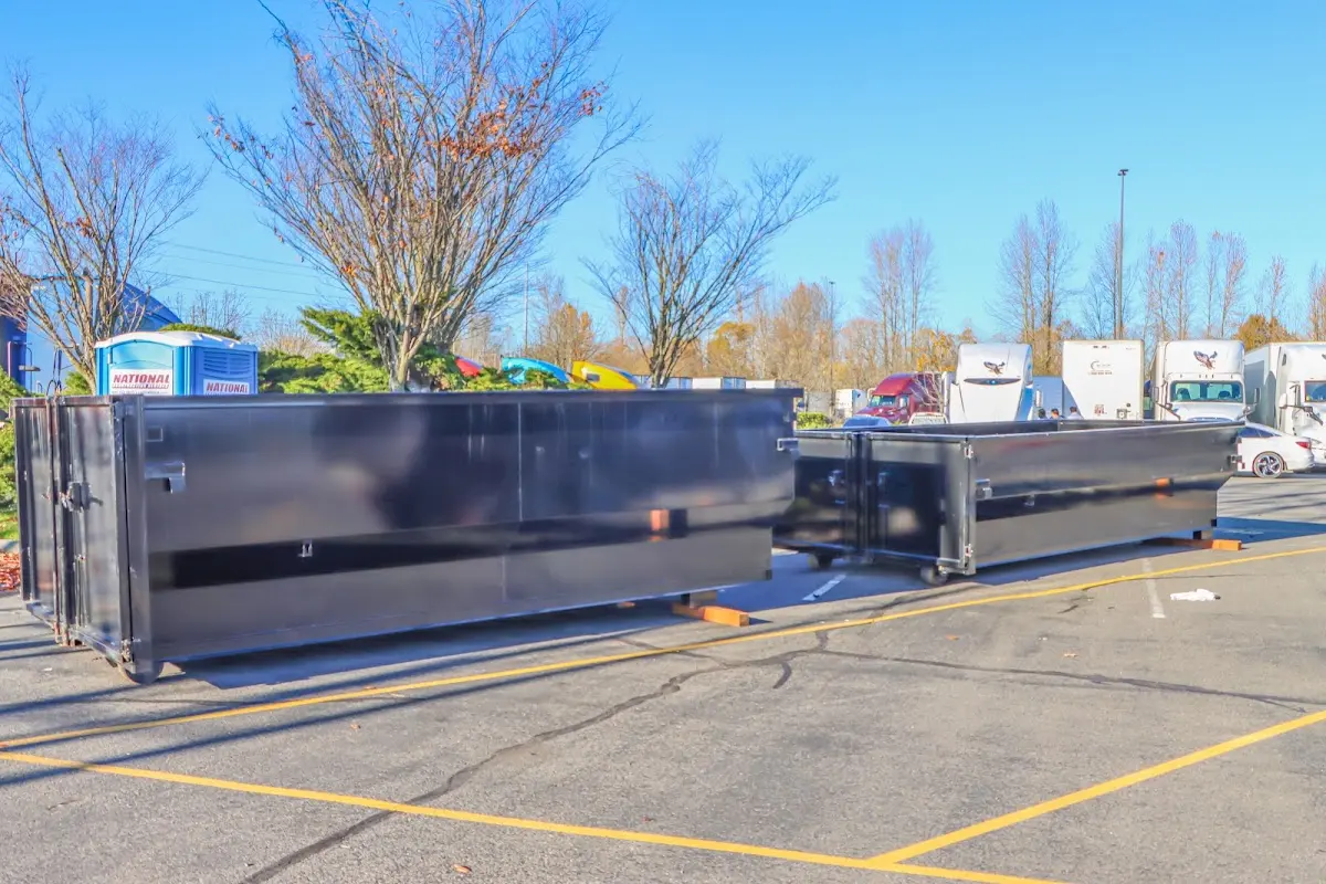 Professional dumpster rental service with roll-off container on residential driveway in Timberlane